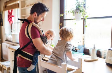 Dad and two kids washing the dishes