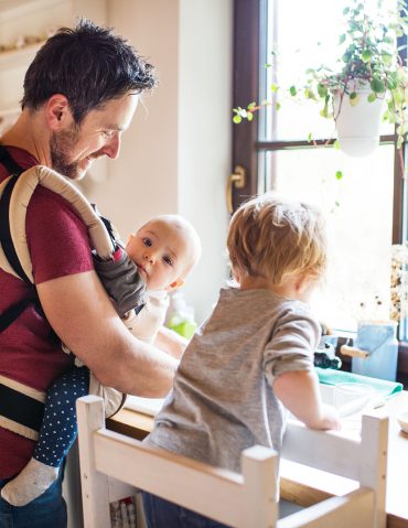 Dad and two kids washing the dishes