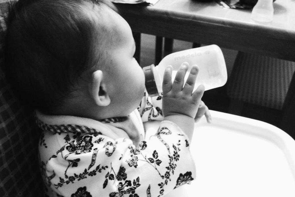 Baby drinking milk black and white