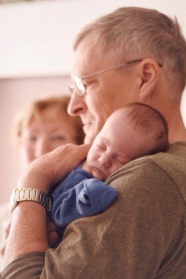 Grandparent holding newborn