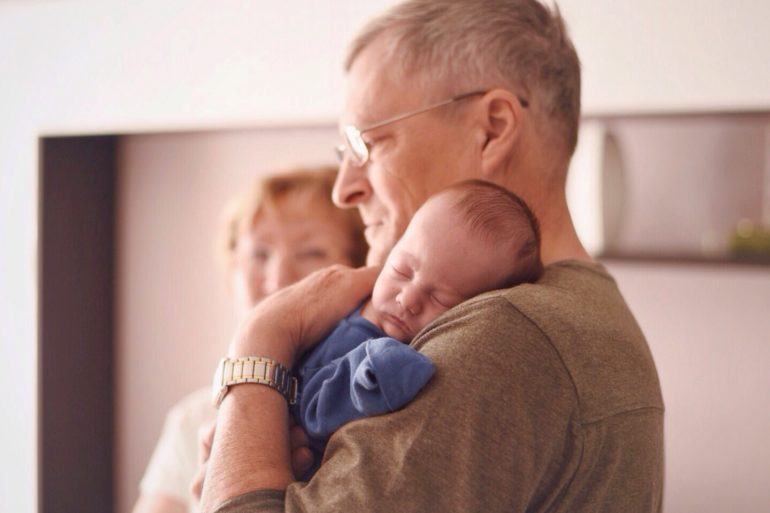 Grandparent holding newborn