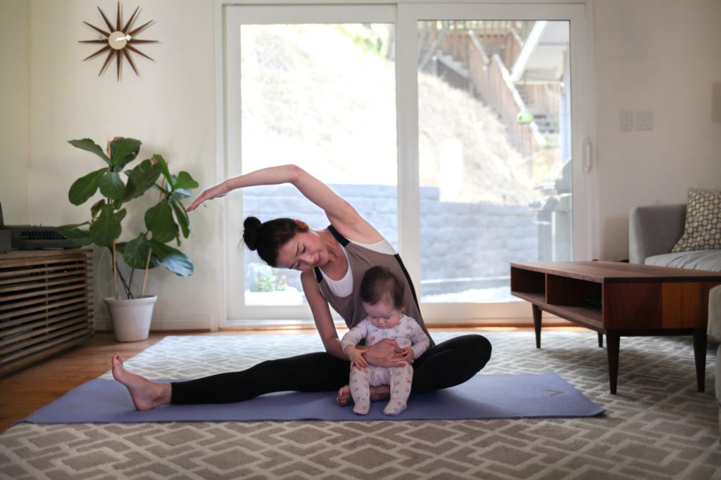 Mother stretching with baby