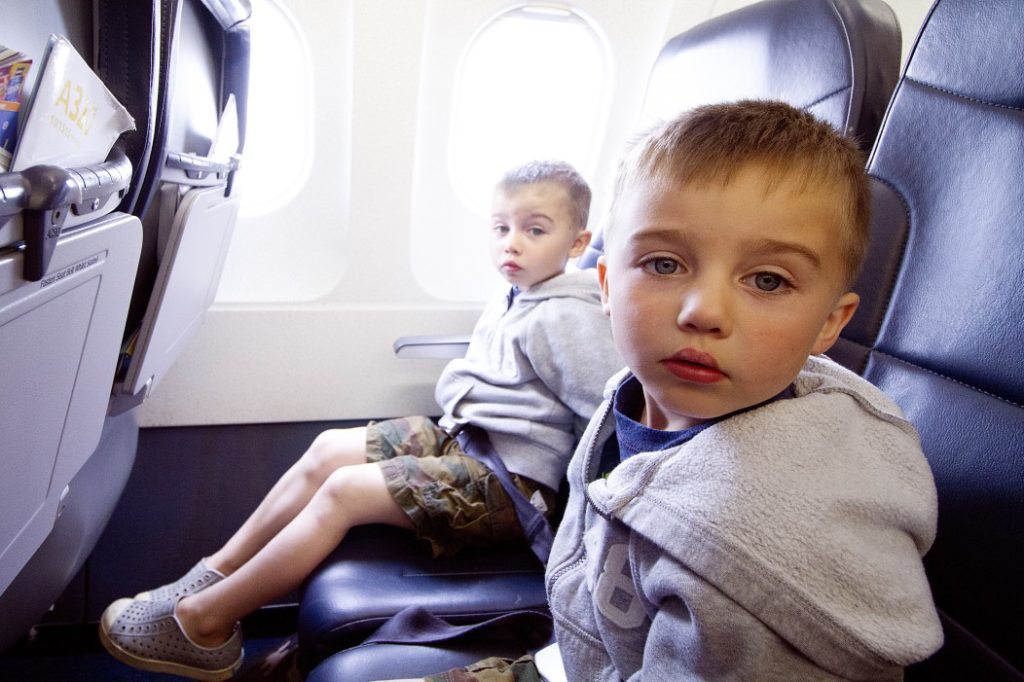 Keep kids buckled on a flight to avoid having them up and about when they're not supposed to be.