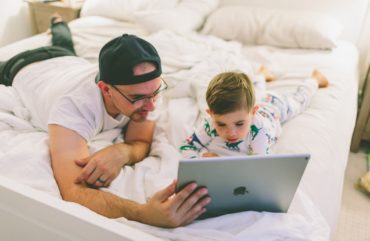 Dad and son looking at ipad screen