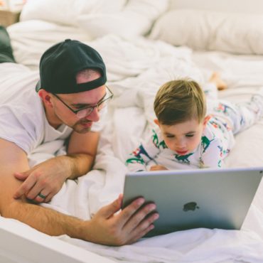 Dad and son looking at ipad screen