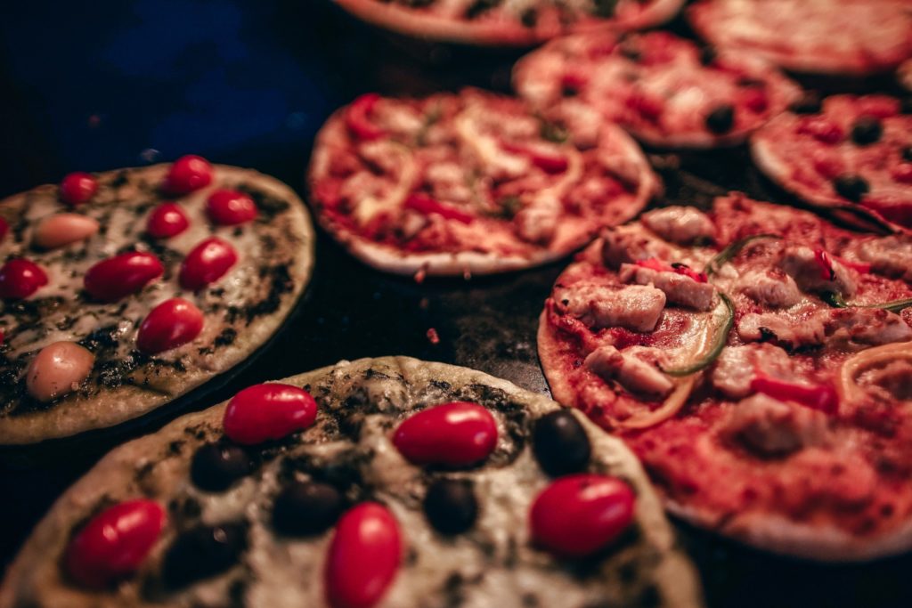 Close up of mini pizzas cooking in the oven