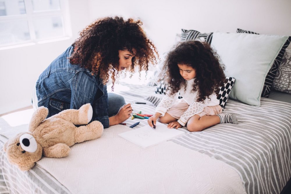 Mom and daughter in bedroom coloring