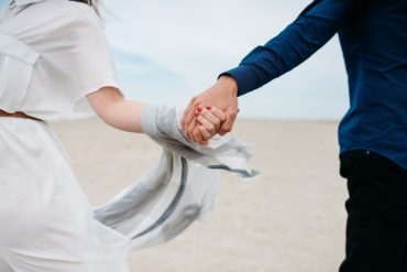 Close up of married couple holding hands