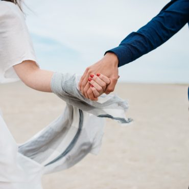 Close up of married couple holding hands