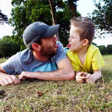 Father and son playing in a field