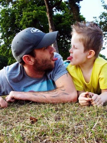 Father and son playing in a field