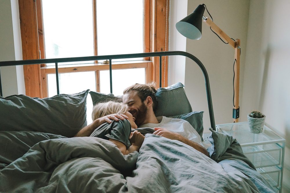 happy couple in bed