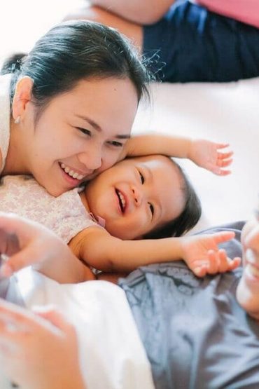 Family cuddling in bed