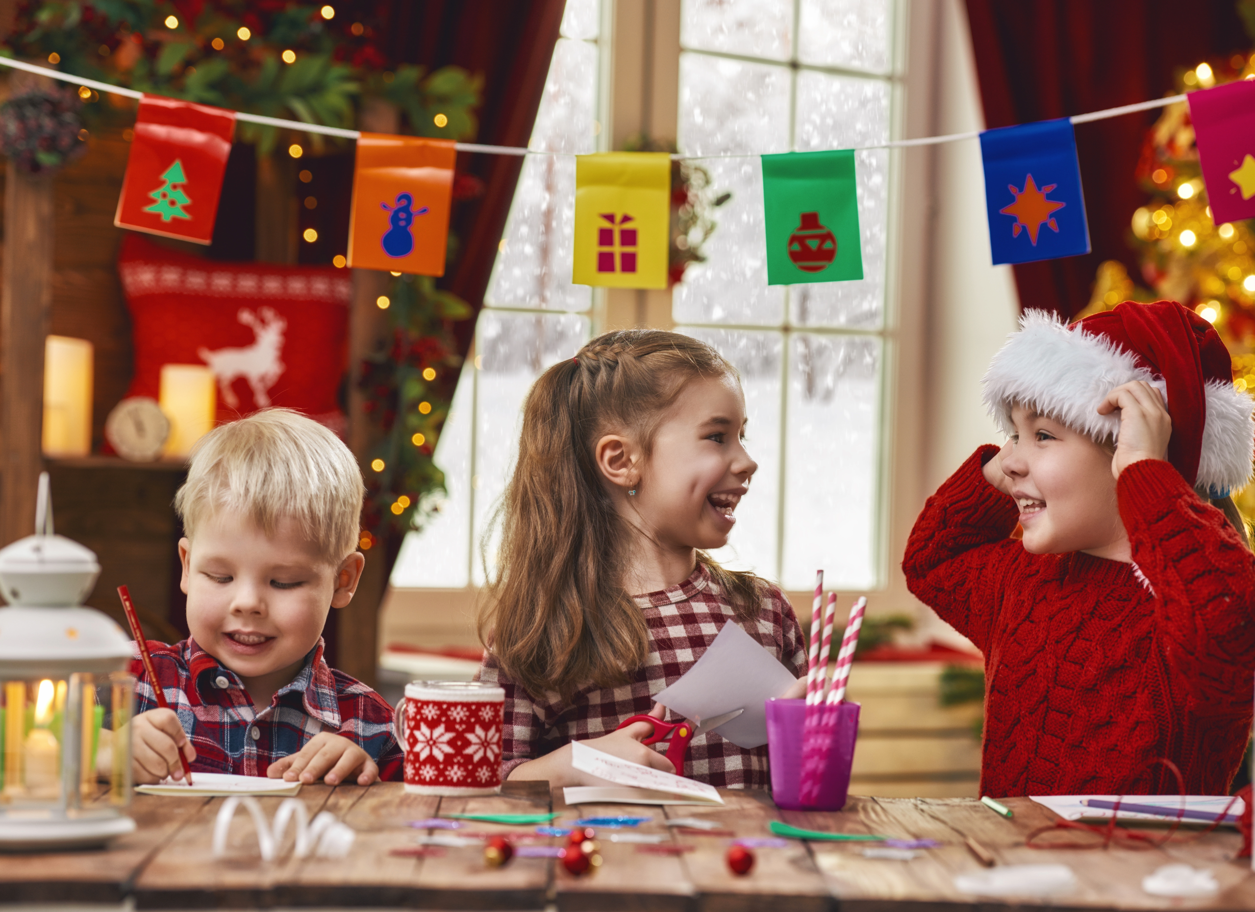 Siblings making Christmas cards.